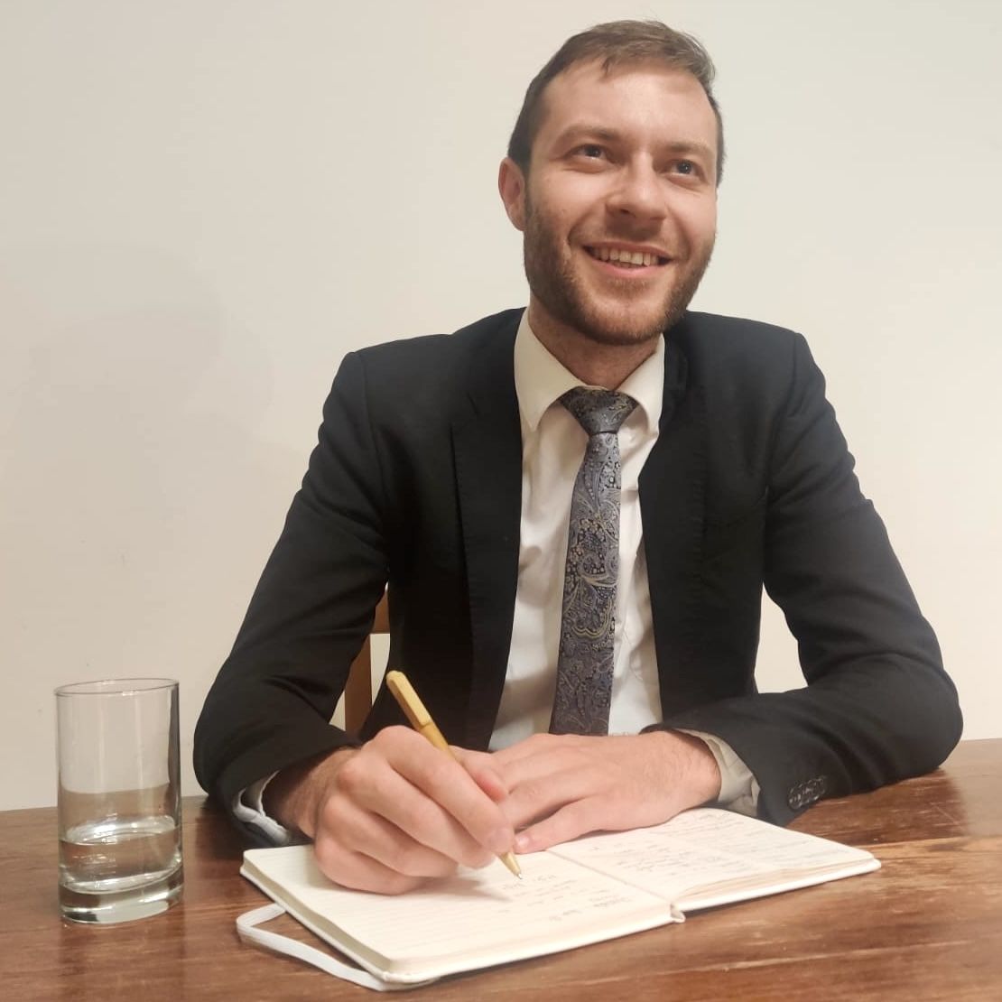 Rav Isaac writing therapy notes at desk